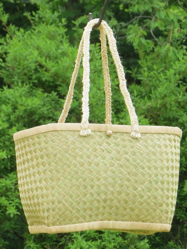 14. Large, functional basket braided of Haravola grass. The braiding technique used implies that raffia palm leaves are laid over the edge of each bundle of grass straw during braiding. The long handles are braided of sisal. Click on the link below for more information about this basket. 
