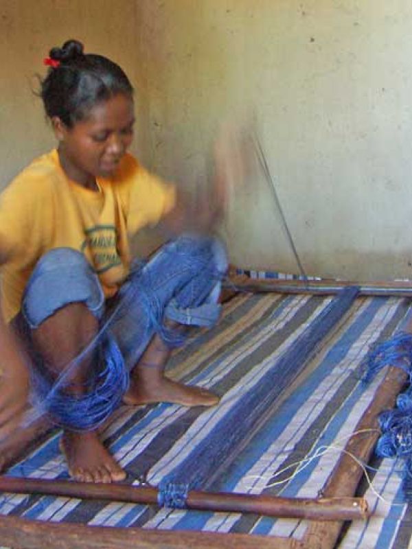 10. Mme Lanto sets up the piece in the handloom. The work is swift.