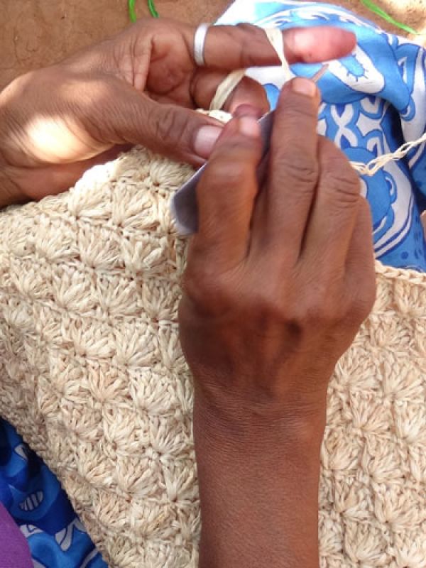 3 Madame Denise crocheting the raffia palm leaves to pattern. Here it will be a bag.